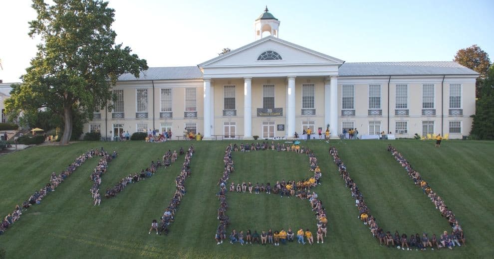 students spelling out MBU on the hill