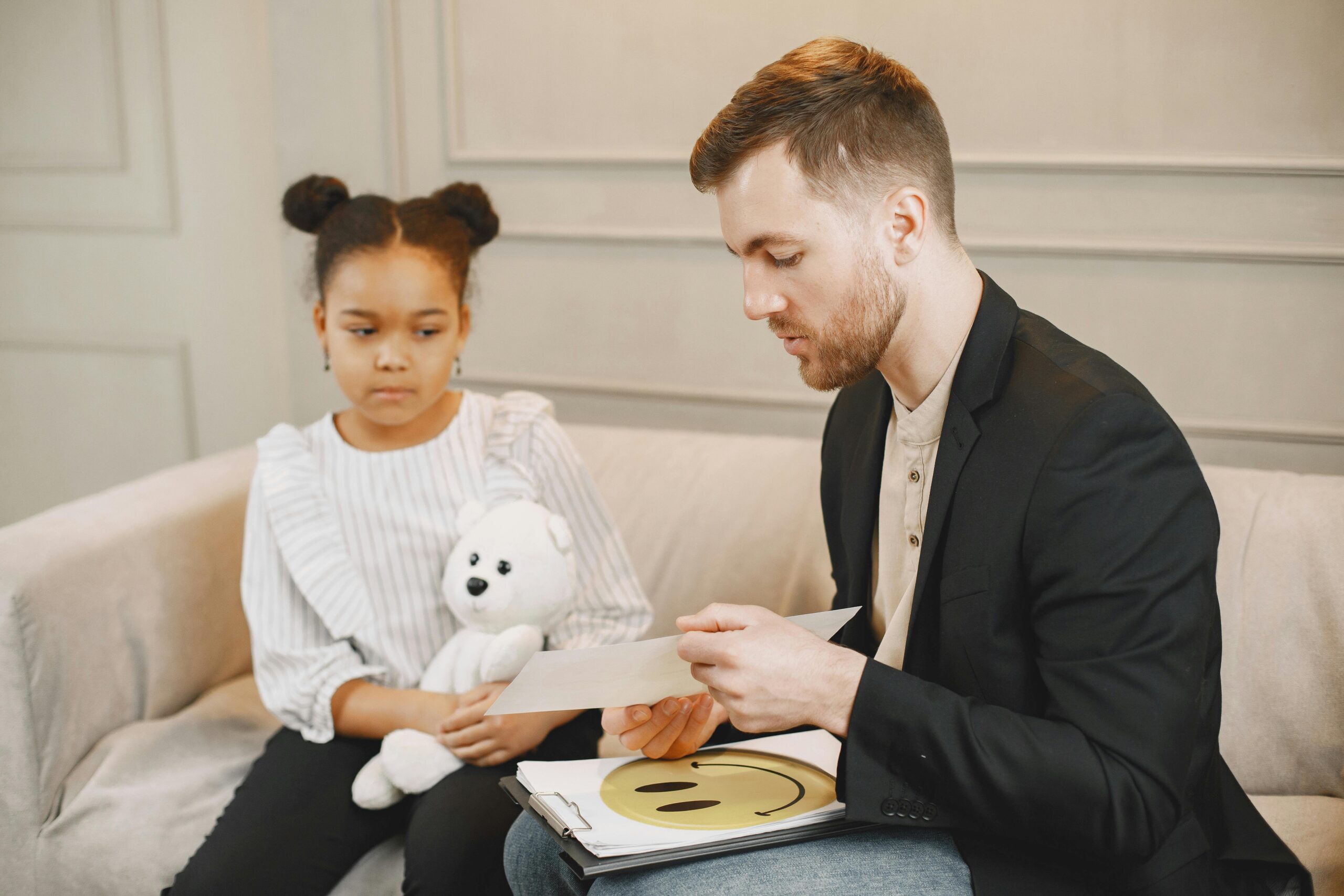 A behavioral therapist counsels a young girl