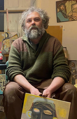 Zachary "Angus" Carter holds a painting he's completed.