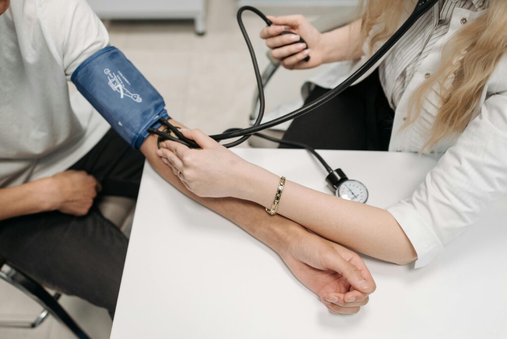 A nurse takes a man's blood pressure.