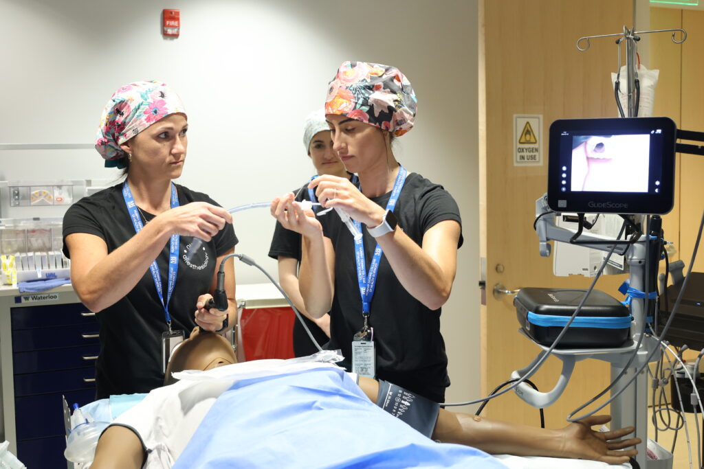 CRNA students administer a breathing tube to a medical mannequin