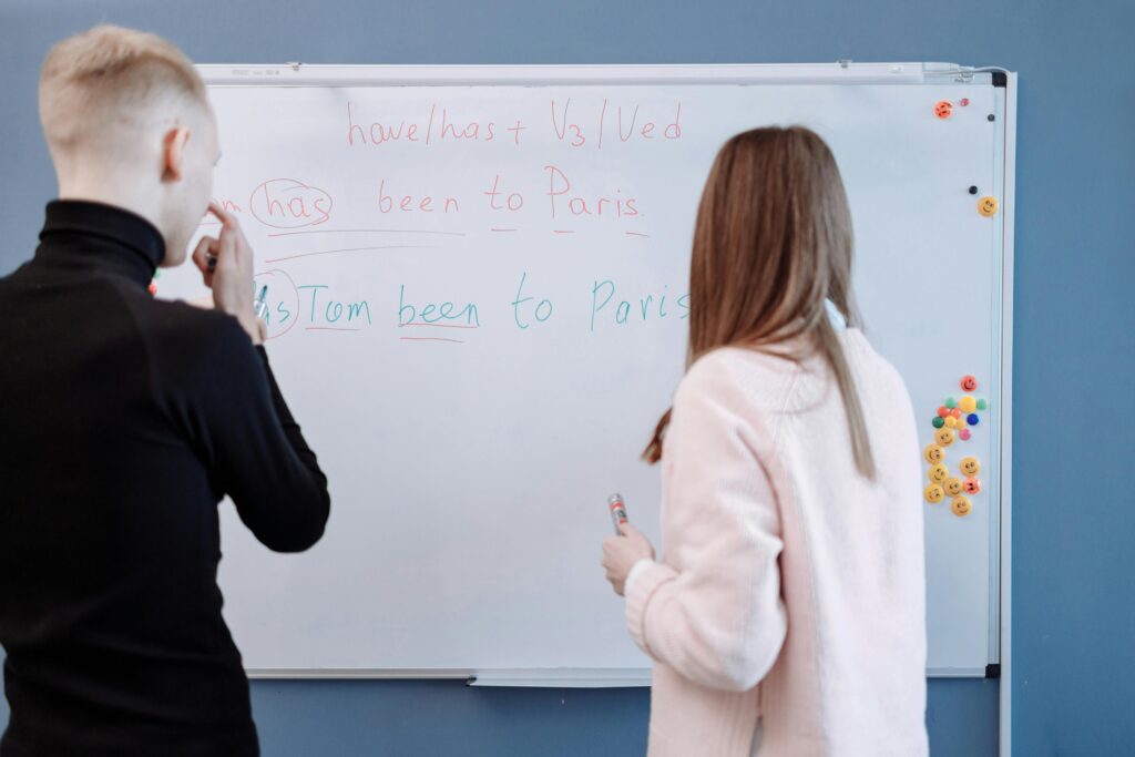 A teacher instructs a student in speaking English