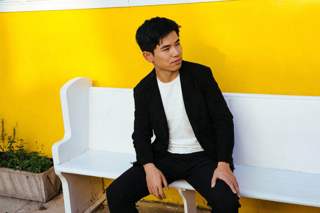 Photo of Zhu Wang sitting on bench