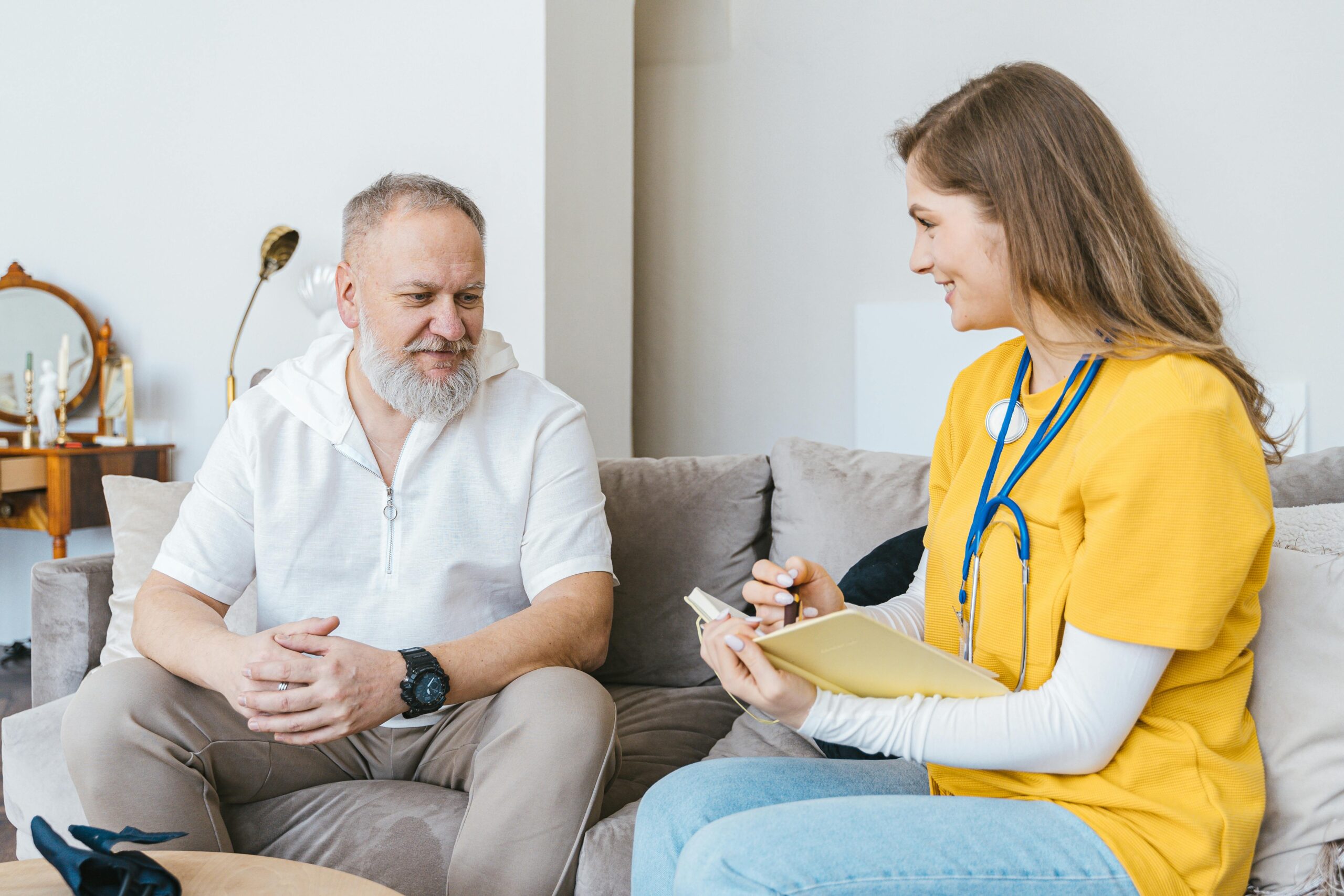 A nurse sits with a patient