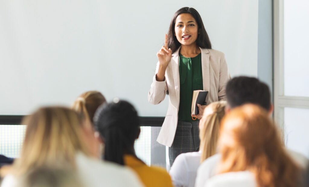 A professor teaches a class of young adults