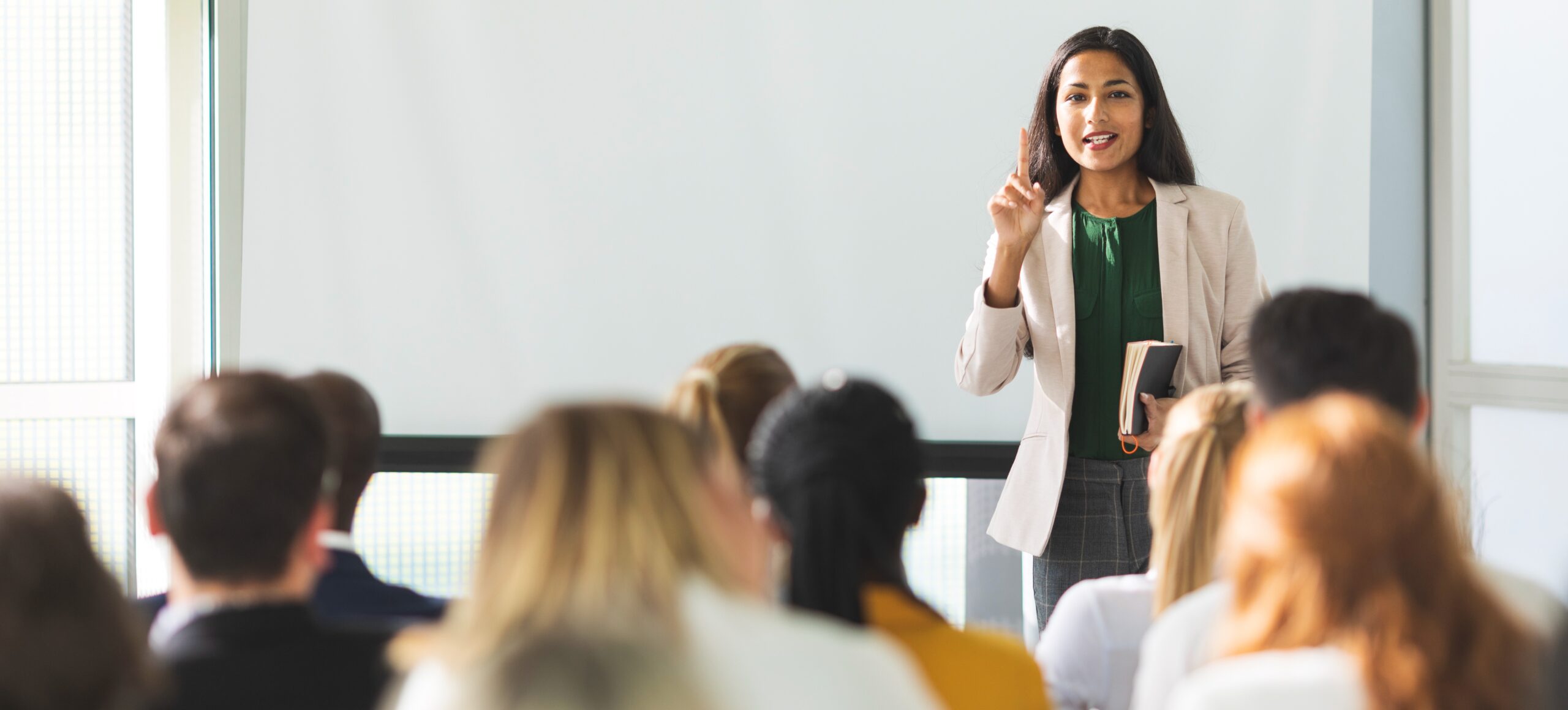 A professor teaches a class of young adults