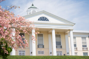 Springtime Image of Hunt Dining Hall, with flowering trees in foreground