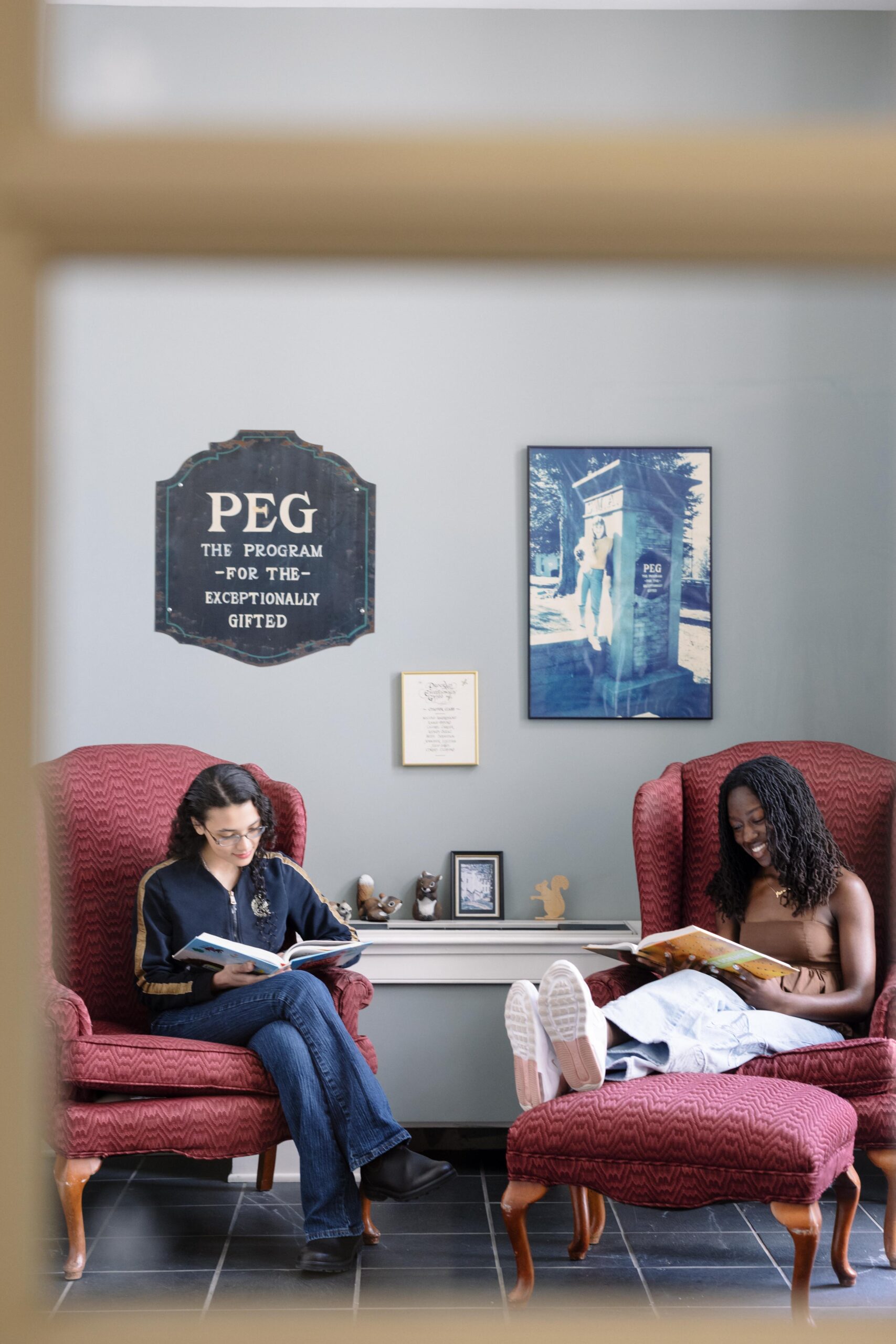 Two PEG students read in the PEG lounge