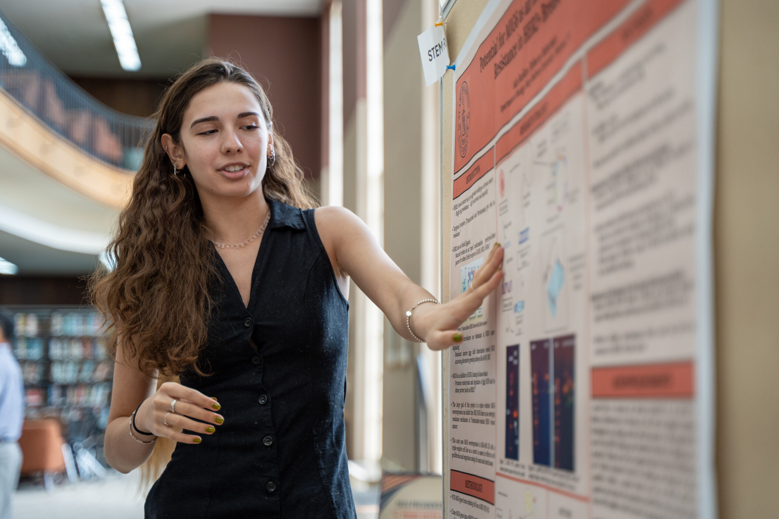 A student presents her poster at the Capstone Festival