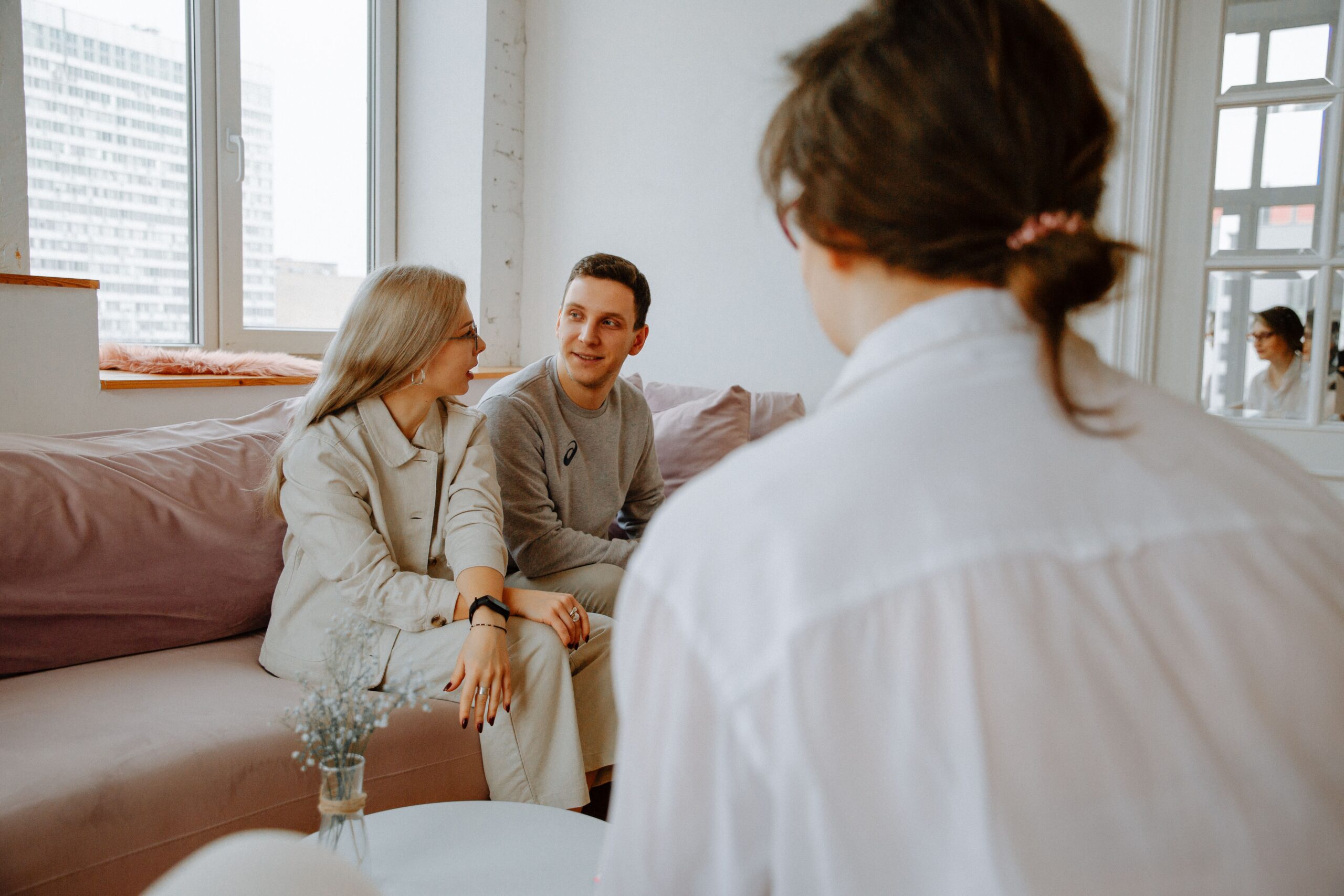 A marriage counselors speaks with a couple