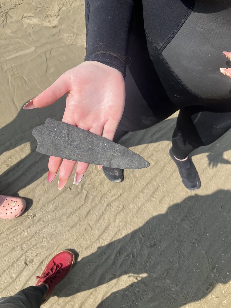 Close-up image of the spearhead in student's hand, on the beach it was found.